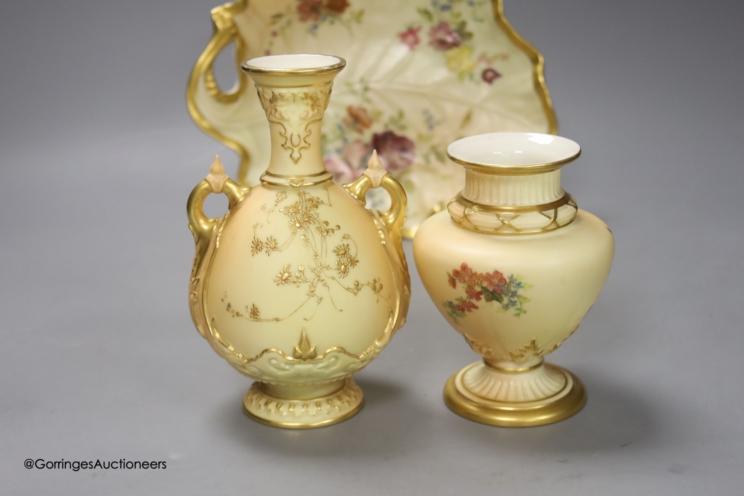 A Royal Worcester blush leaf dish, a pair of ewers, a two handled vase and another